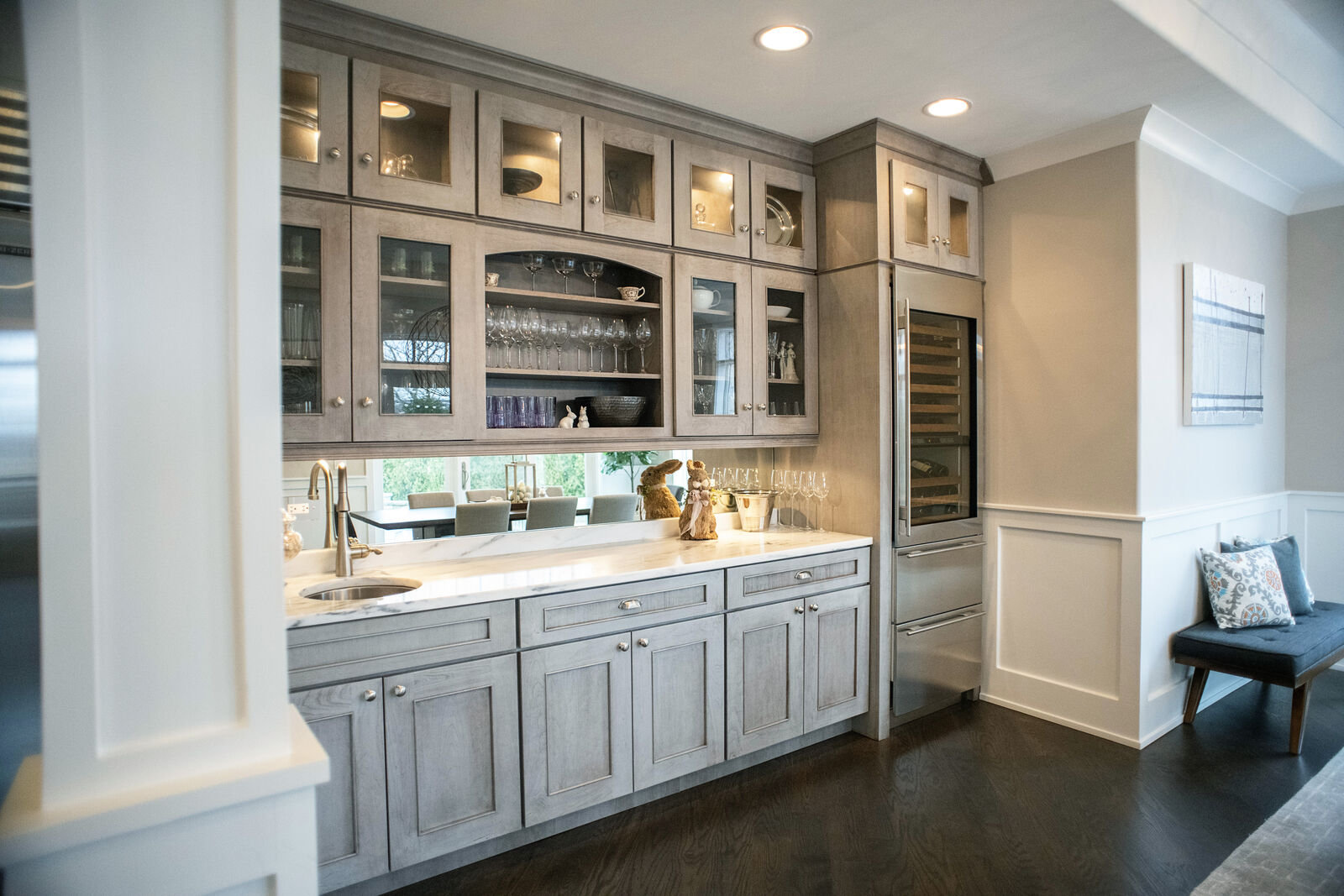 Butler's pantry with glass front cabinets, a wine refrigerator and a prep sink